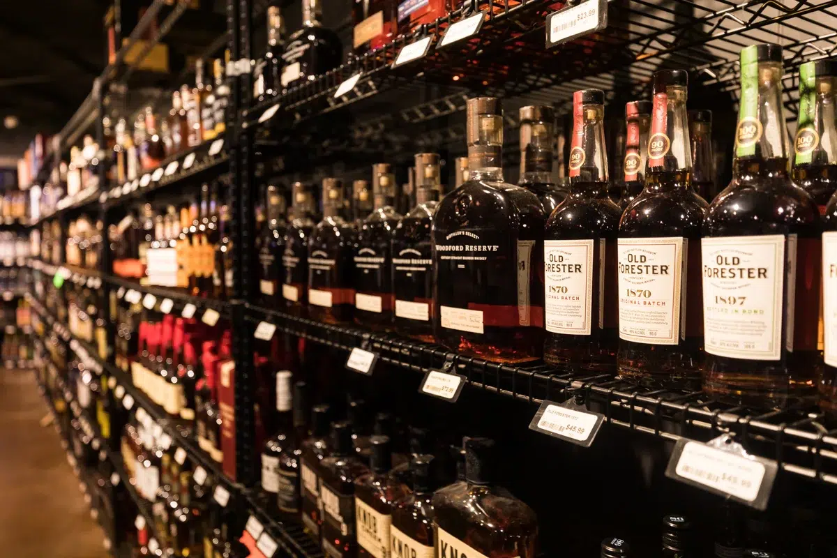 Assorted whiskey bottles on store shelves.
