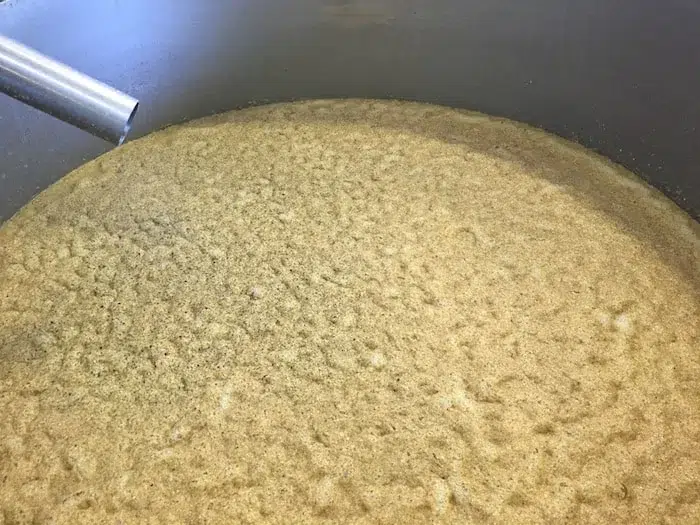 Close-up of brewing whiskey mash in kettle.