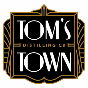 Tom's Town Distilling Co. logo in art deco style.