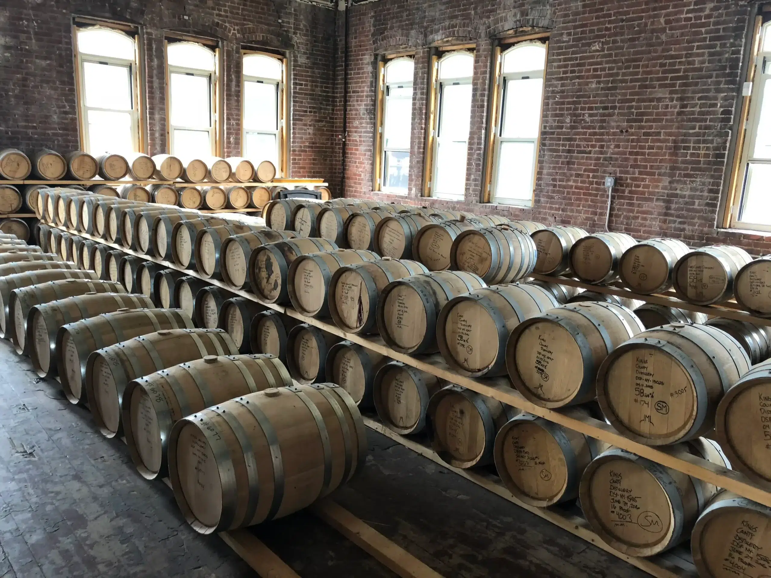 Whiskey barrels aging in a distillery warehouse.