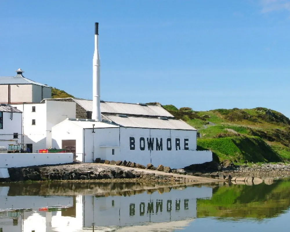Bowmore distillery by the water with reflection.