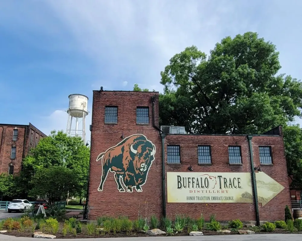 Buffalo Trace Distillery exterior with bison mural and water tower.