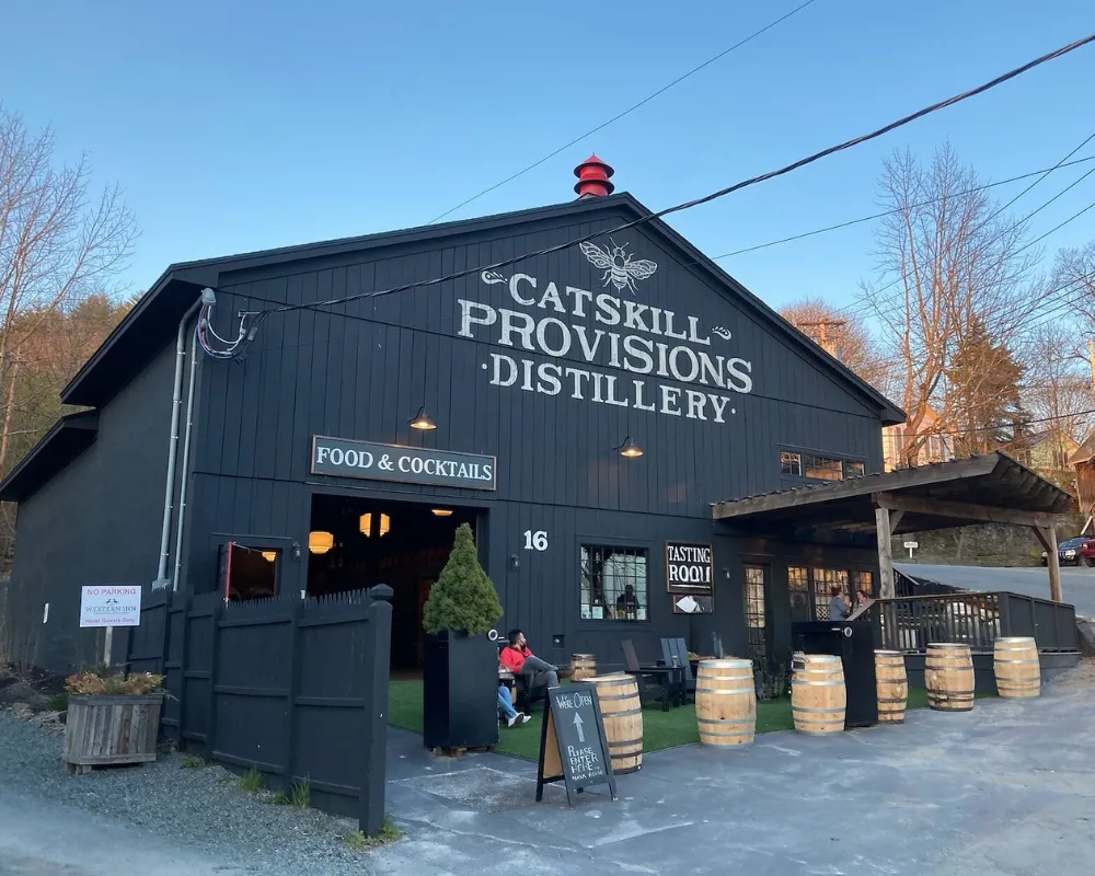 Catskill Provisions Distillery exterior with barrels and signage.