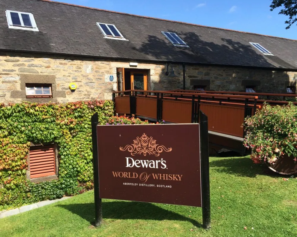 Dewar's distillery entrance with sign in Aberfeldy, Scotland.