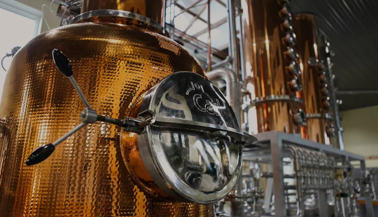 Copper distillery equipment in a spirits production facility.