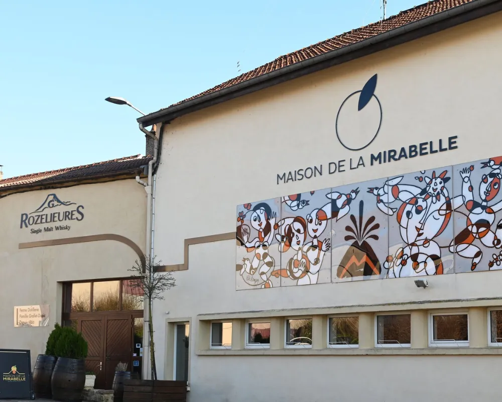Maison de la Mirabelle building exterior with mural.
