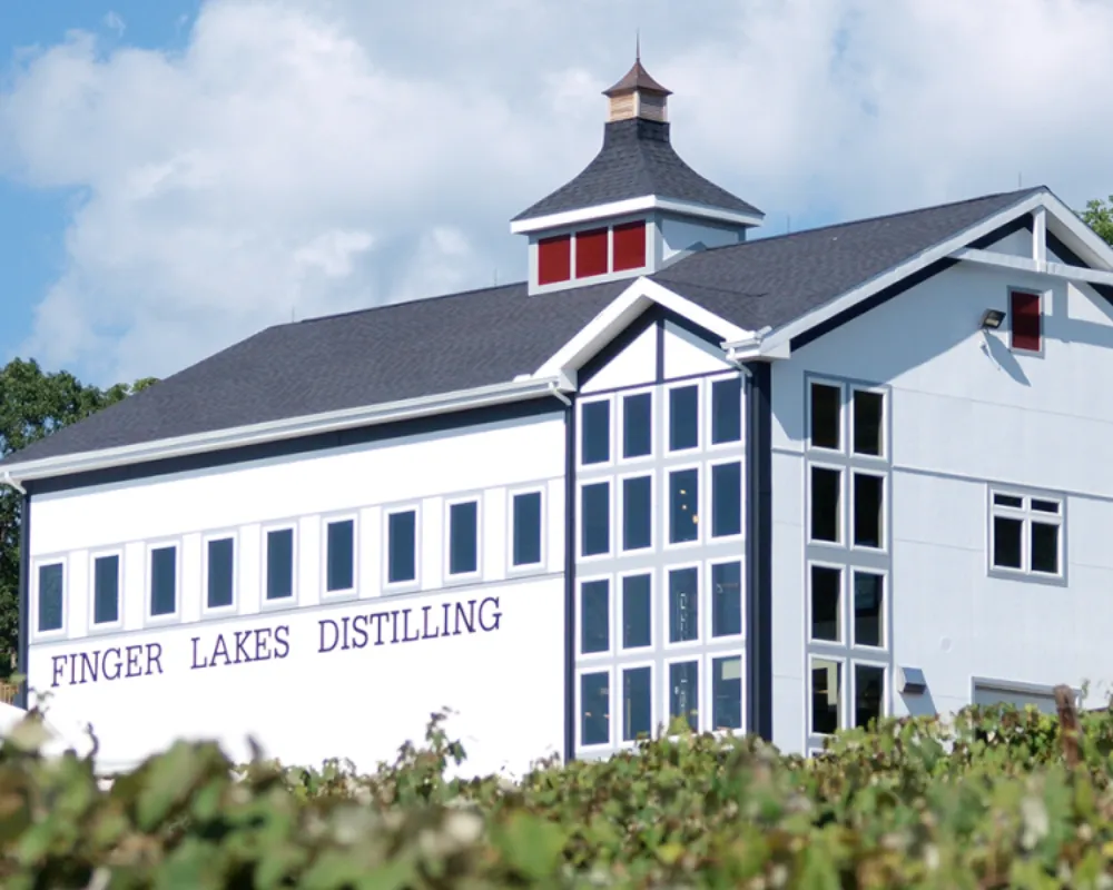 Finger Lakes Distilling building facade with vineyard.