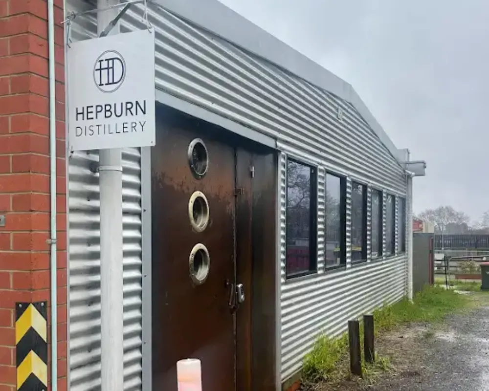 Hepburn Distillery entrance with sign and corrugated metal exterior.