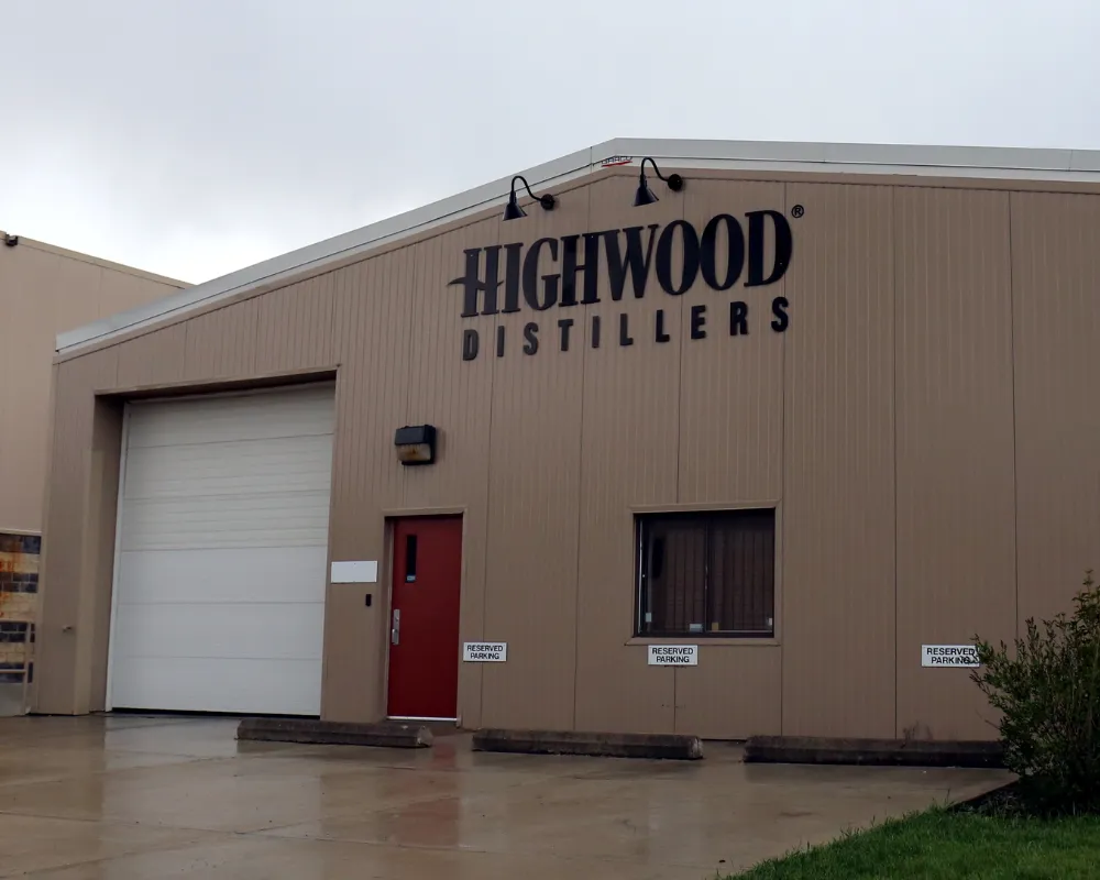 Exterior of Highwood Distillers building on rainy day.