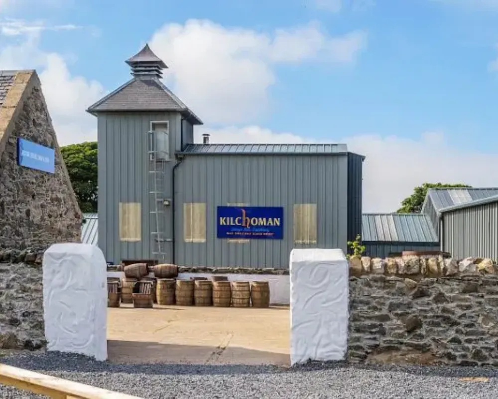 Kilchoman Distillery entrance with whiskey barrels.