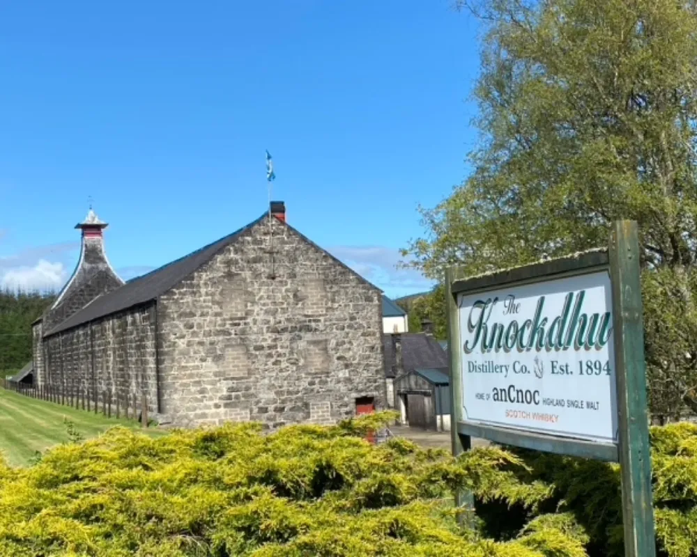 Knockdhu Distillery with sign, Scotland whisky heritage.