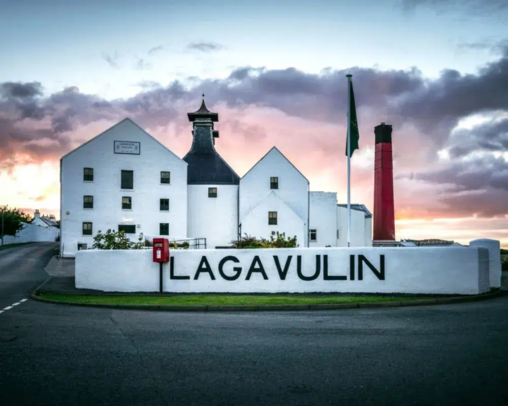 Lagavulin distillery at sunset in Scotland.
