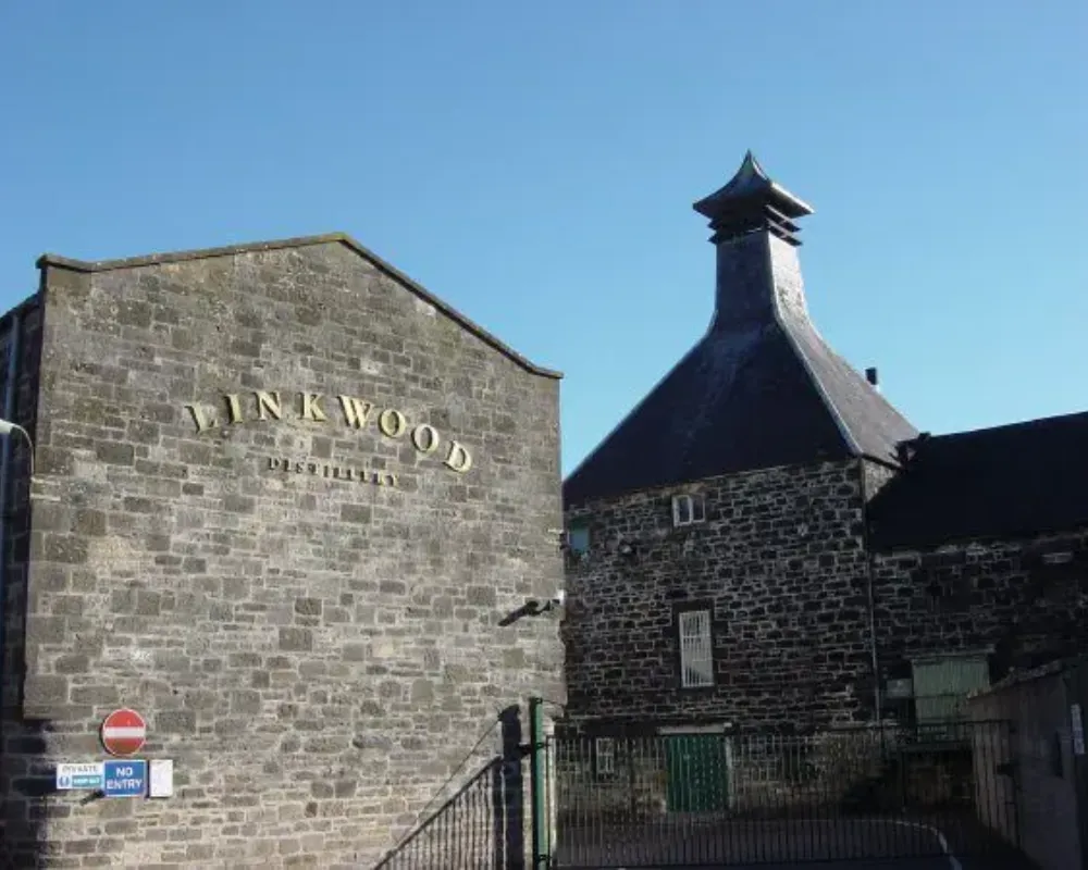 Historic Linkwood Distillery building facade under blue sky.