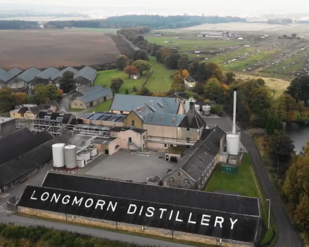 Aerial view of Longmorn Distillery complex and surrounding landscape.