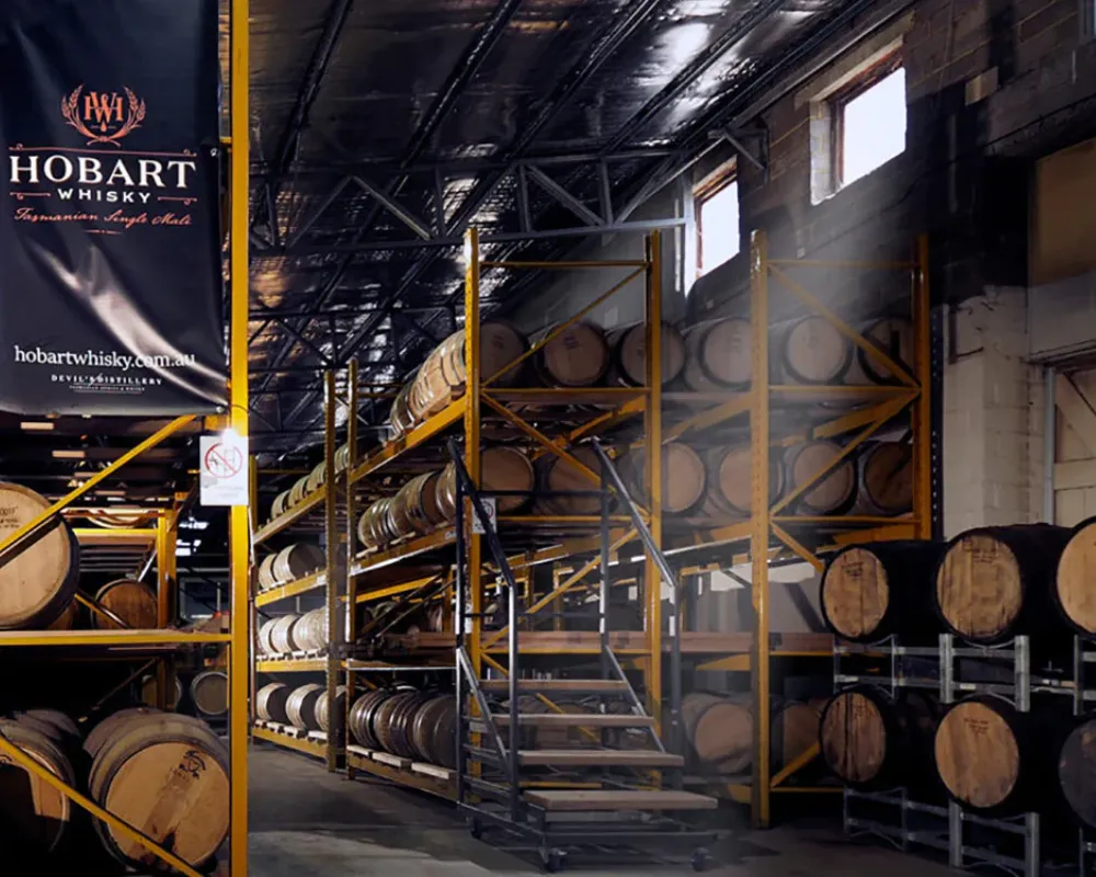 Whisky barrels in distillery storage warehouse