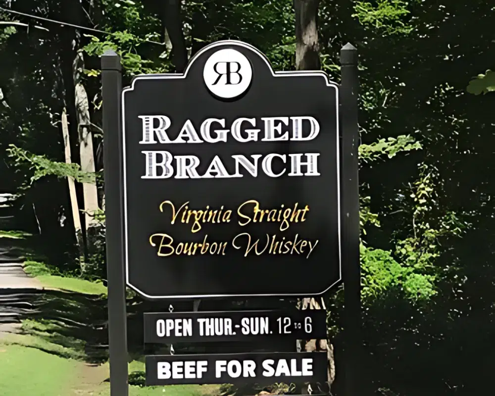 Ragged Branch bourbon whiskey sign with business hours.