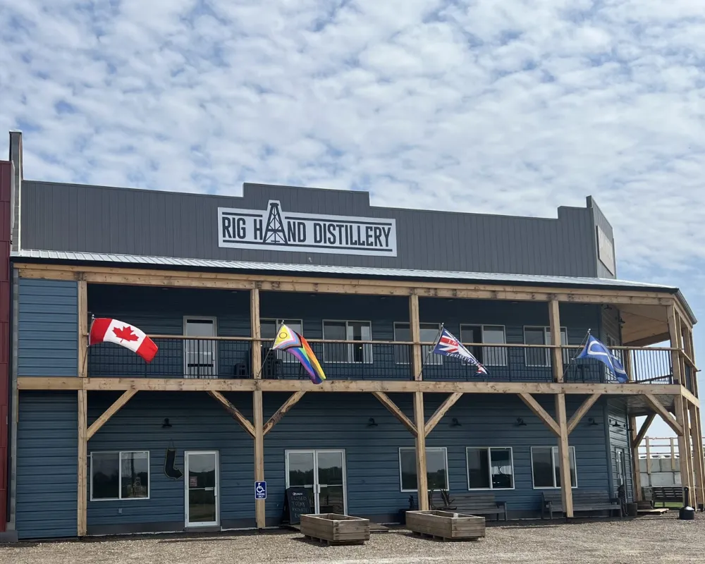 Rig Hand Distillery building exterior with flags.
