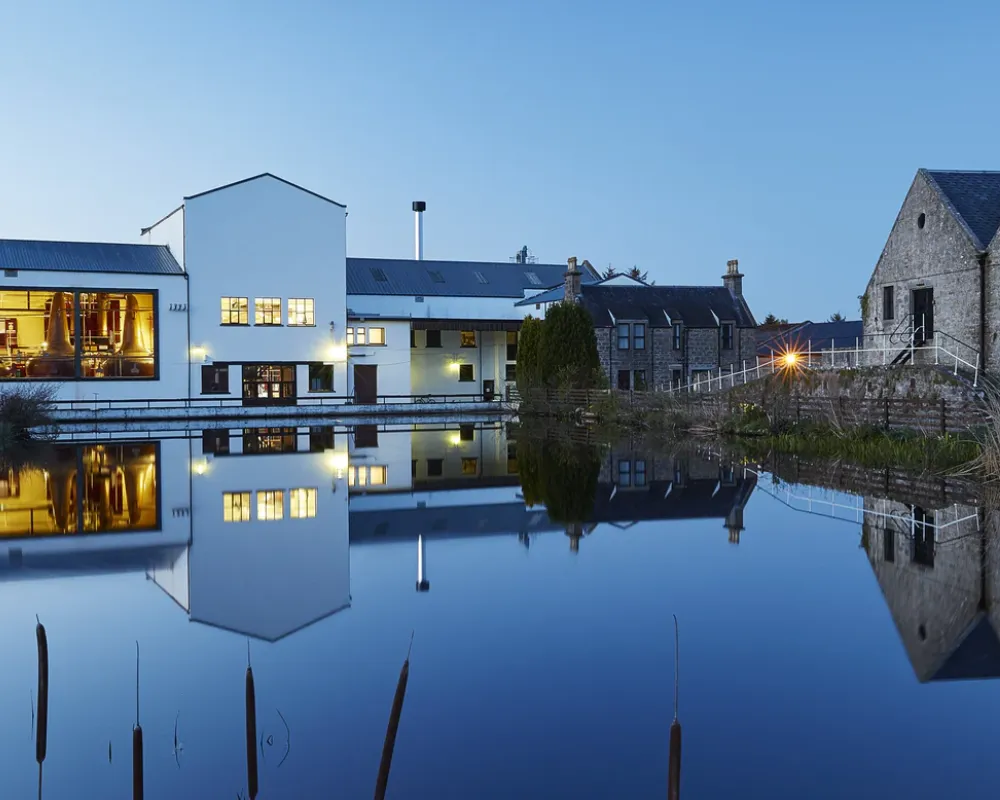 Twilight reflection of modern building and traditional house on water