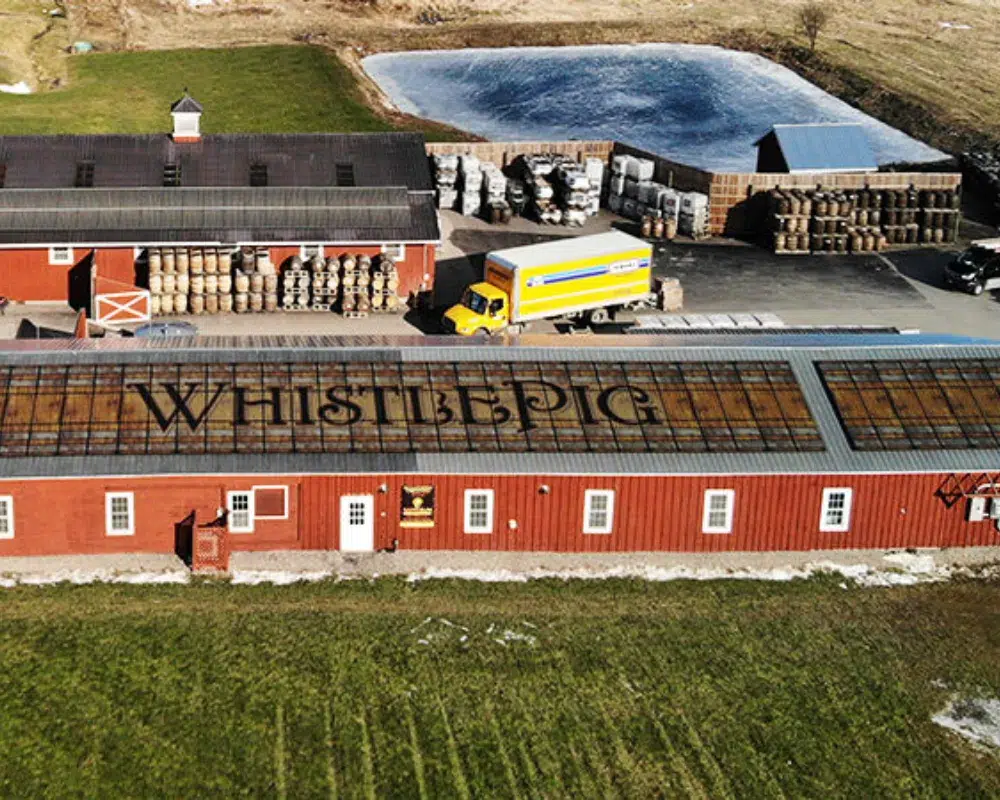 Aerial view of distillery with logo on roof.