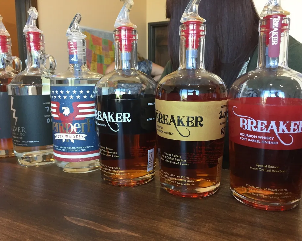 Variety of Breaker bourbon whiskey bottles on table.