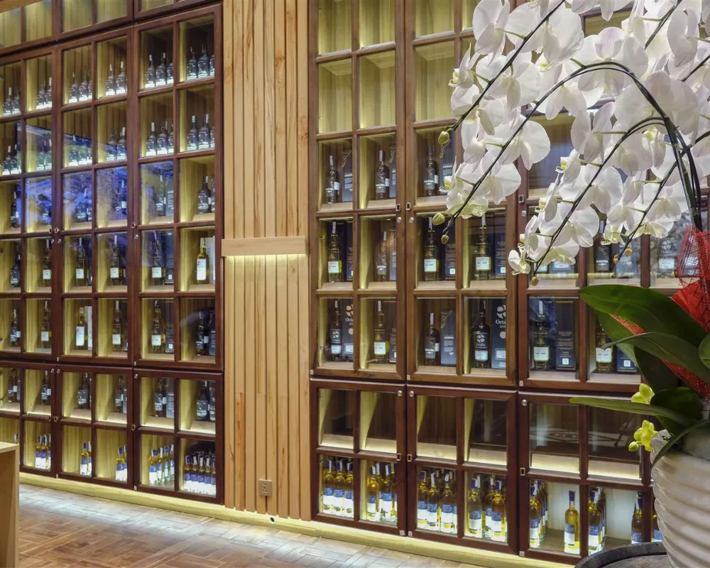Elegant wine cellar with wooden shelves and orchid decoration.