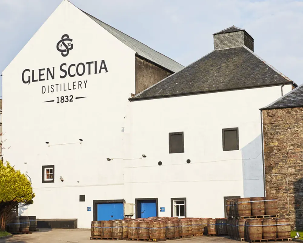 Glen Scotia Distillery exterior with whiskey barrels.