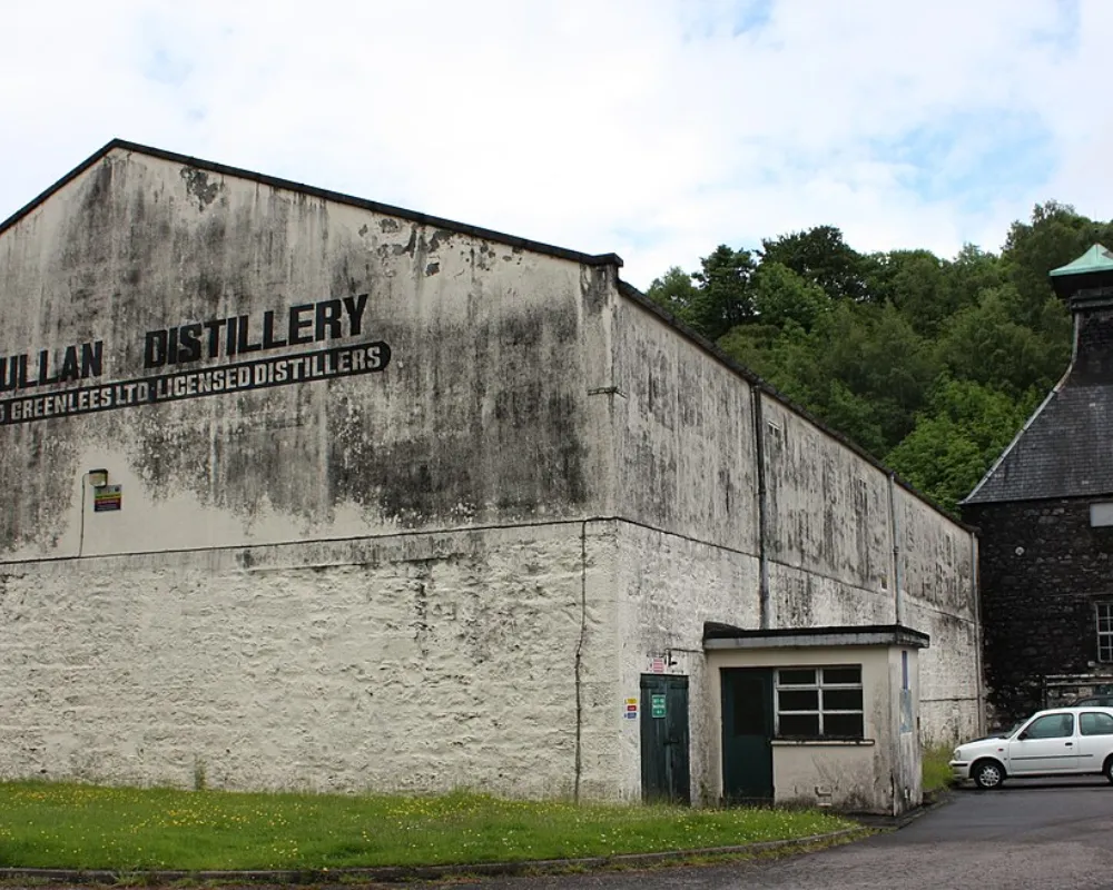 Old distillery building exterior with signage.