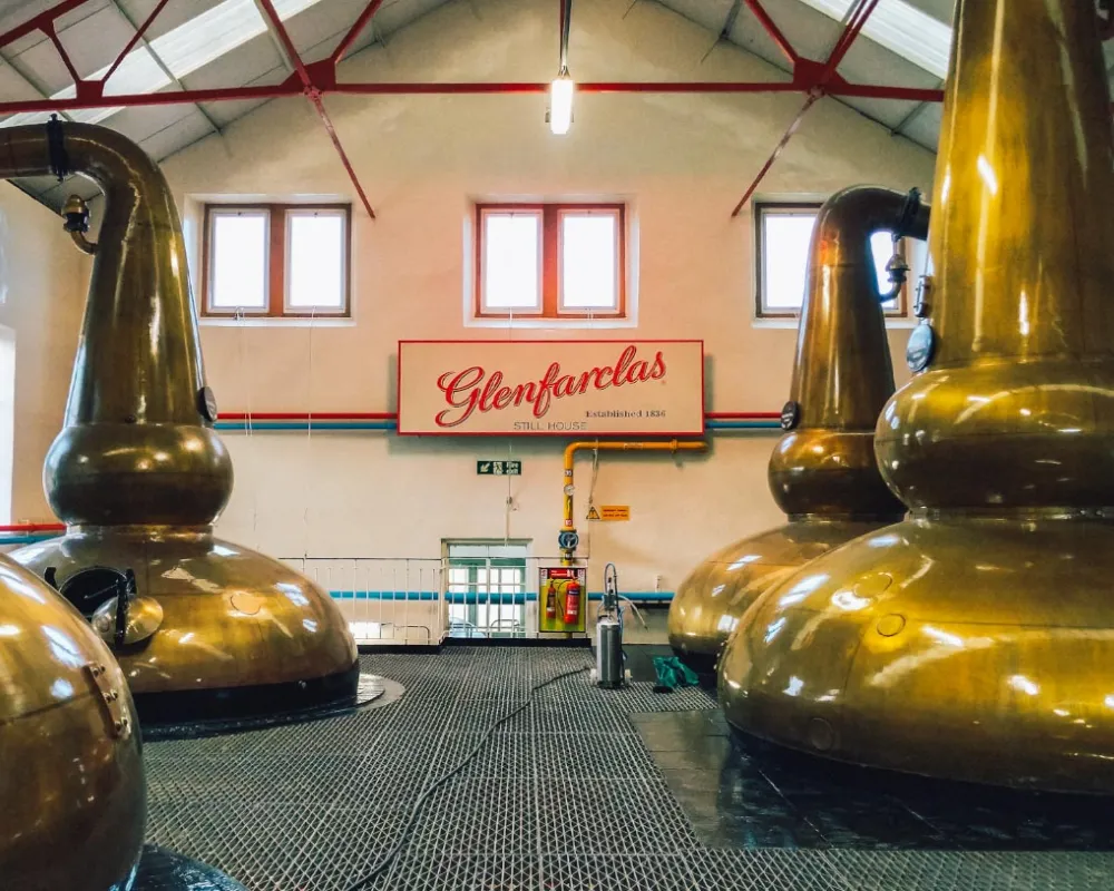 Glenfarclas distillery copper pot stills in production room.