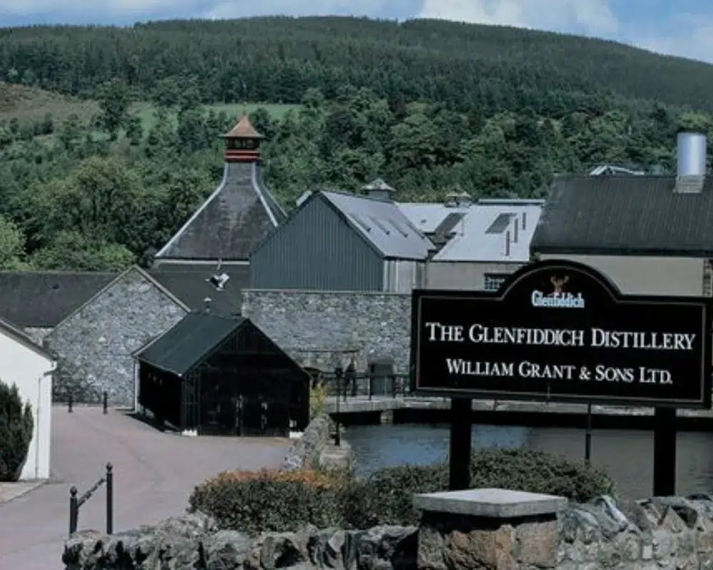 Glenfiddich Distillery exterior with forest backdrop.