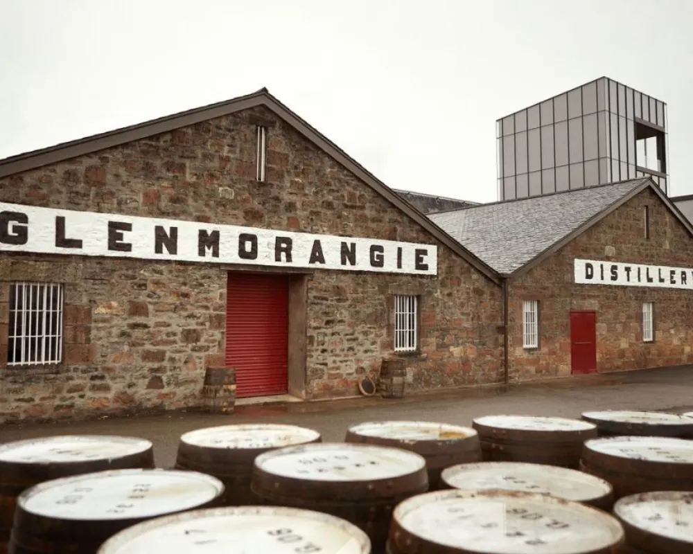 Glenmorangie Distillery exterior with whisky barrels.