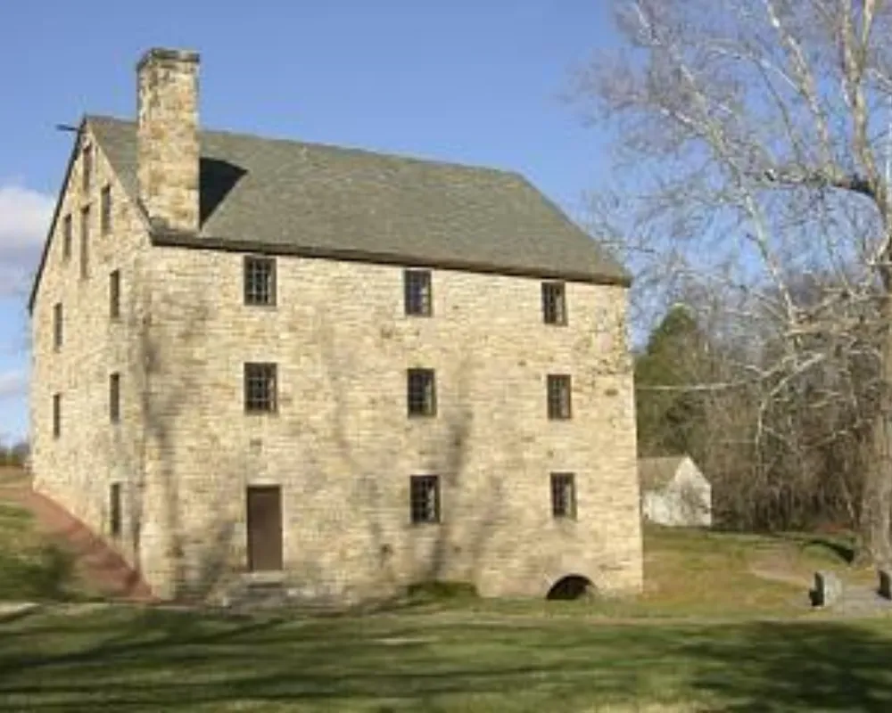 Historic stone mill building on sunny day