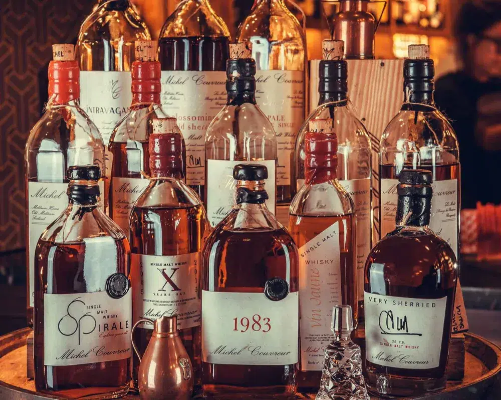 Assorted vintage whiskey bottles on display.