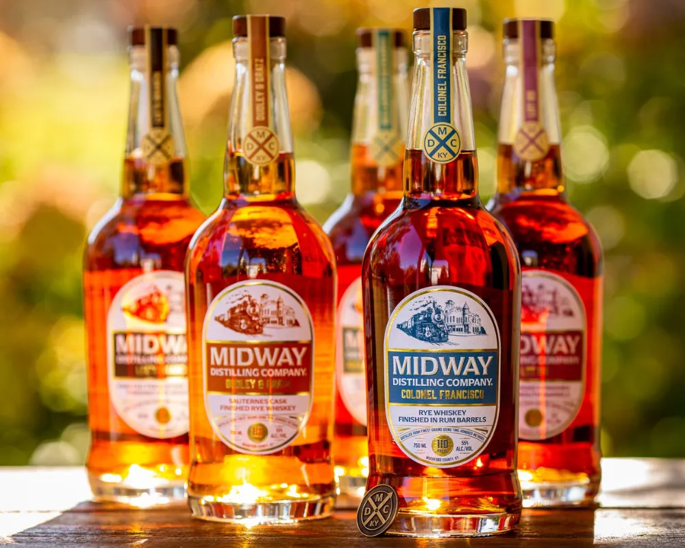 Midway Distilling Company rye whiskey bottles in sunlight.