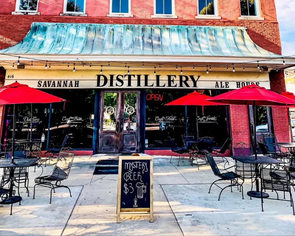 Savannah Distillery Ale House with outdoor seating and umbrellas.