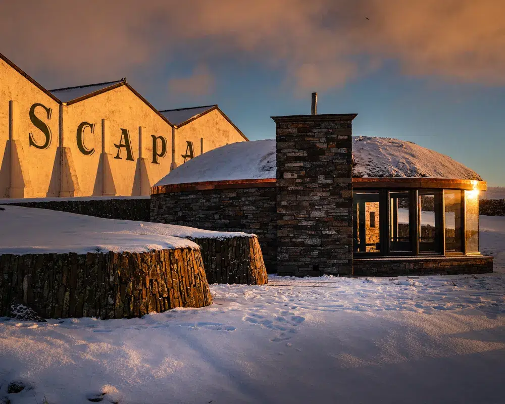 Sunset at snowy distillery with warm lighting
