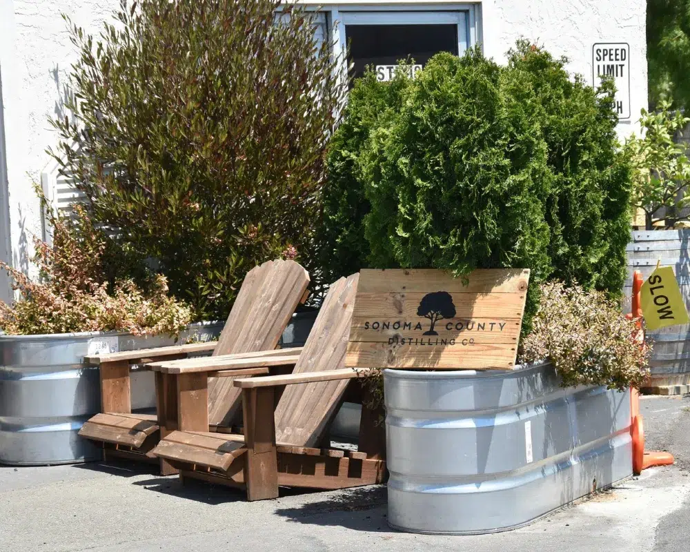 Outdoor street-side seating and planters at distillery.