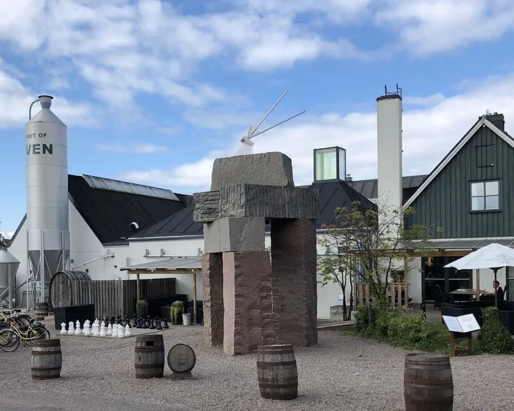 Distillery courtyard with large chess set and barrels.