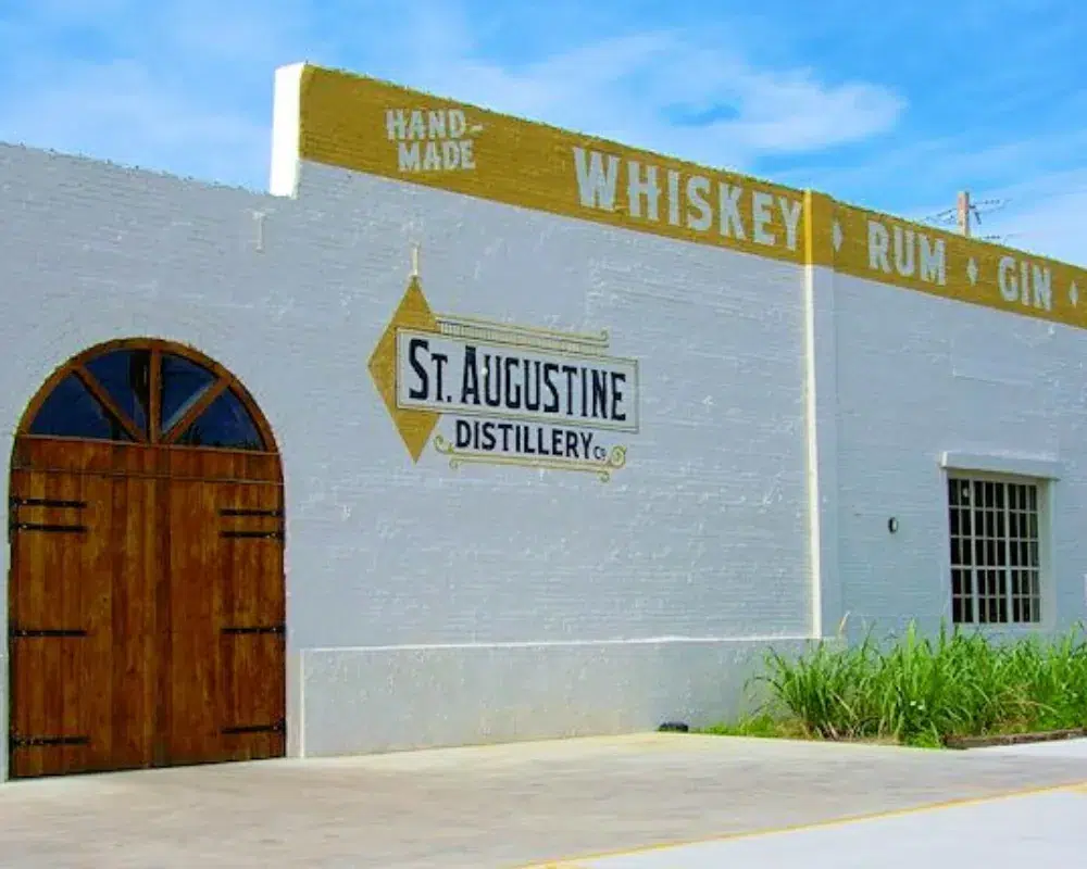 Exterior of St. Augustine Distillery building with signs.