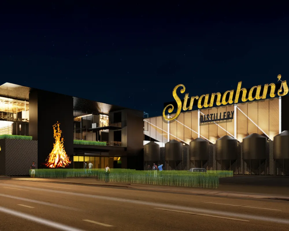 Stranahan's distillery exterior at night with fire feature.