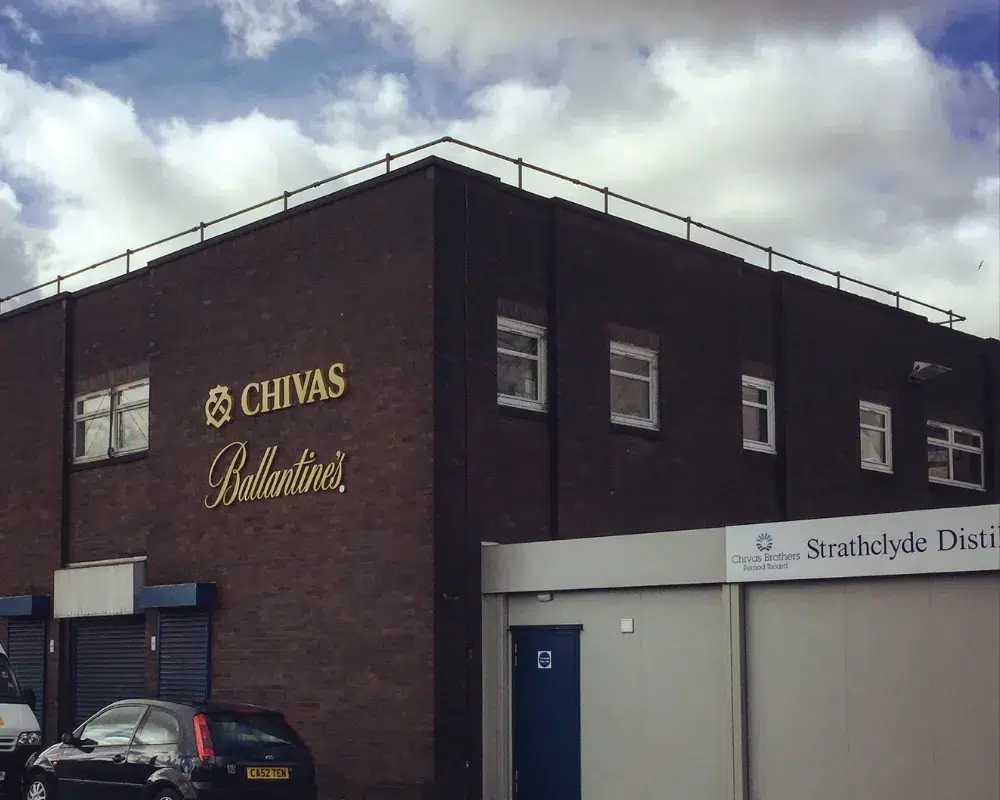 Chivas and Ballantine's brand logos on distillery building