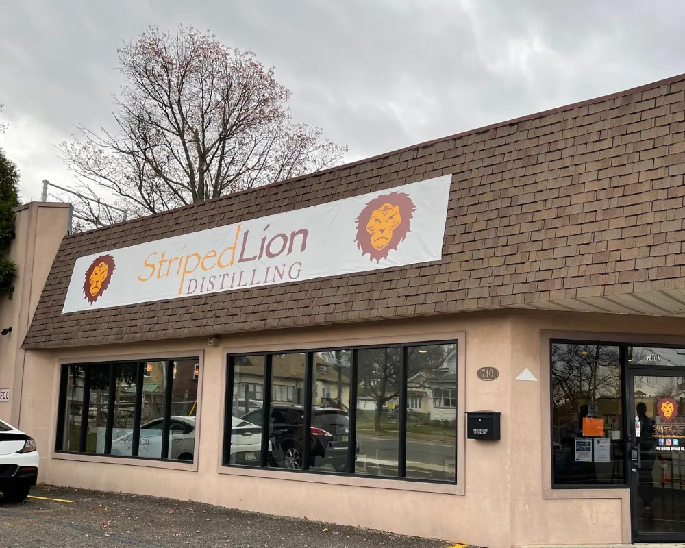 Striped Lion Distilling storefront with logo banner.