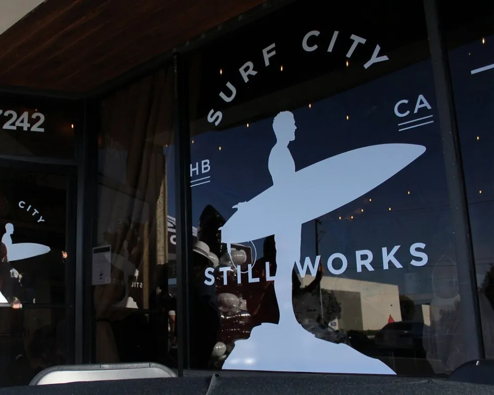 Surf City Still Works shopfront window with logo.