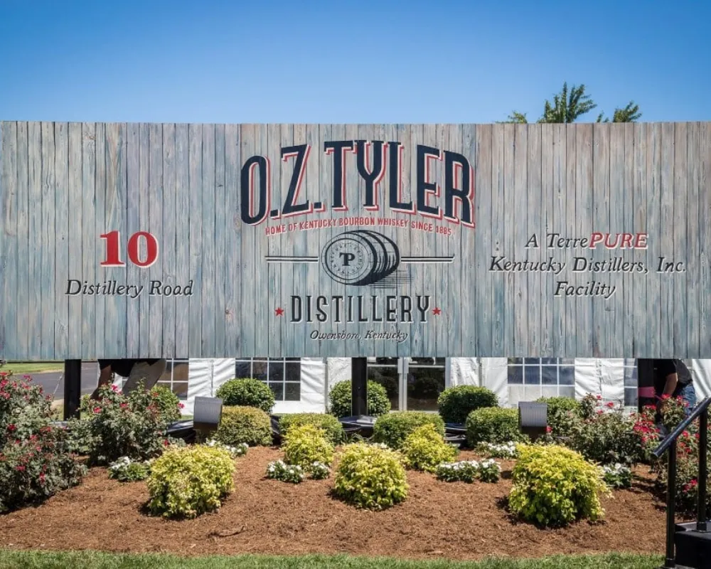 O.Z. Tyler Distillery entrance with signage and garden.