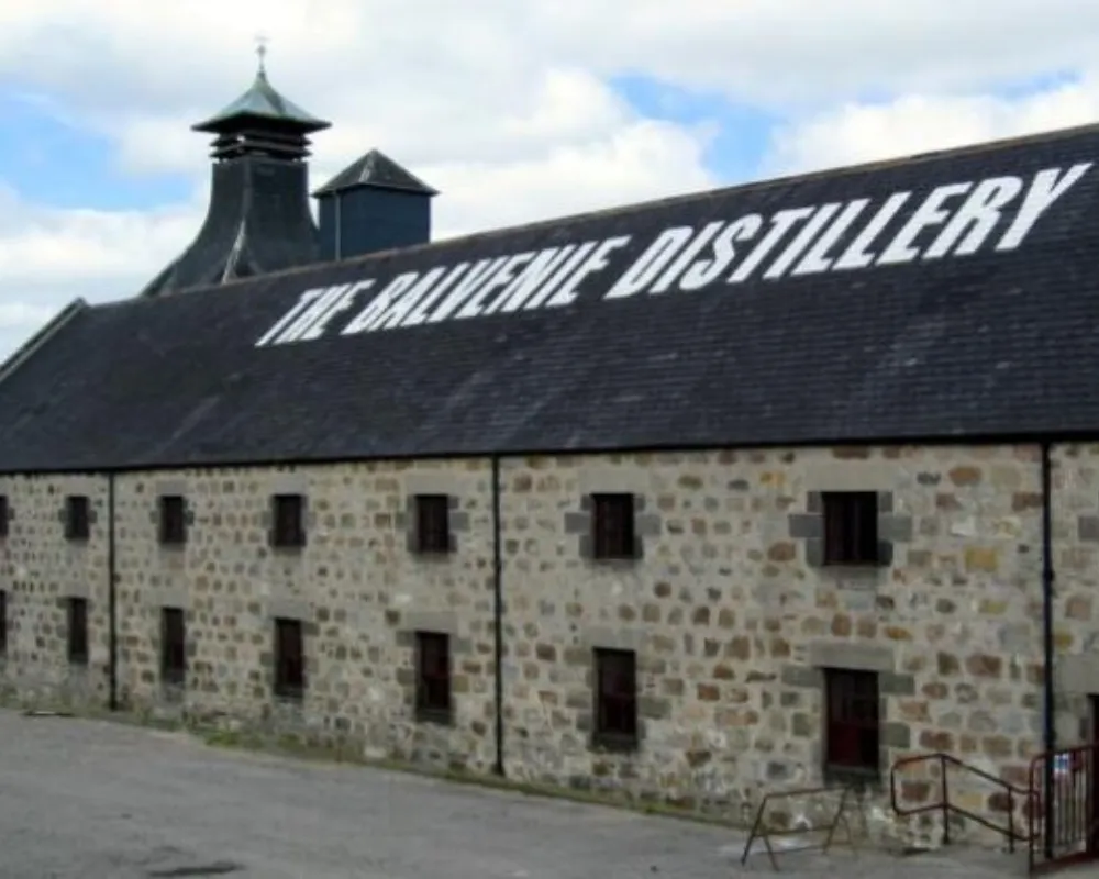 The Balvenie Distillery building exterior with sign.