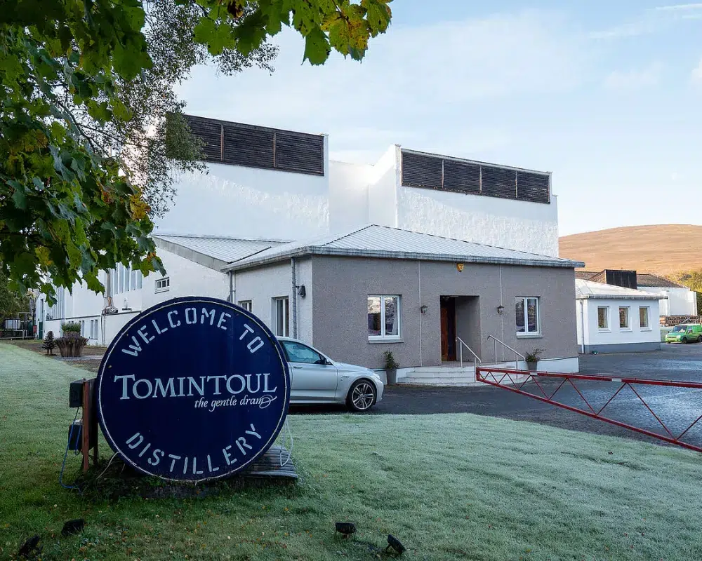 Tomintoul Distillery exterior with welcome sign.