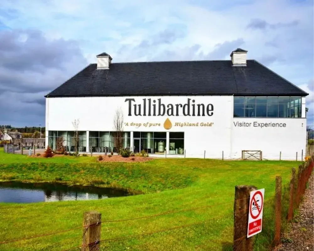 Tullibardine Distillery exterior with pond and no swimming sign.