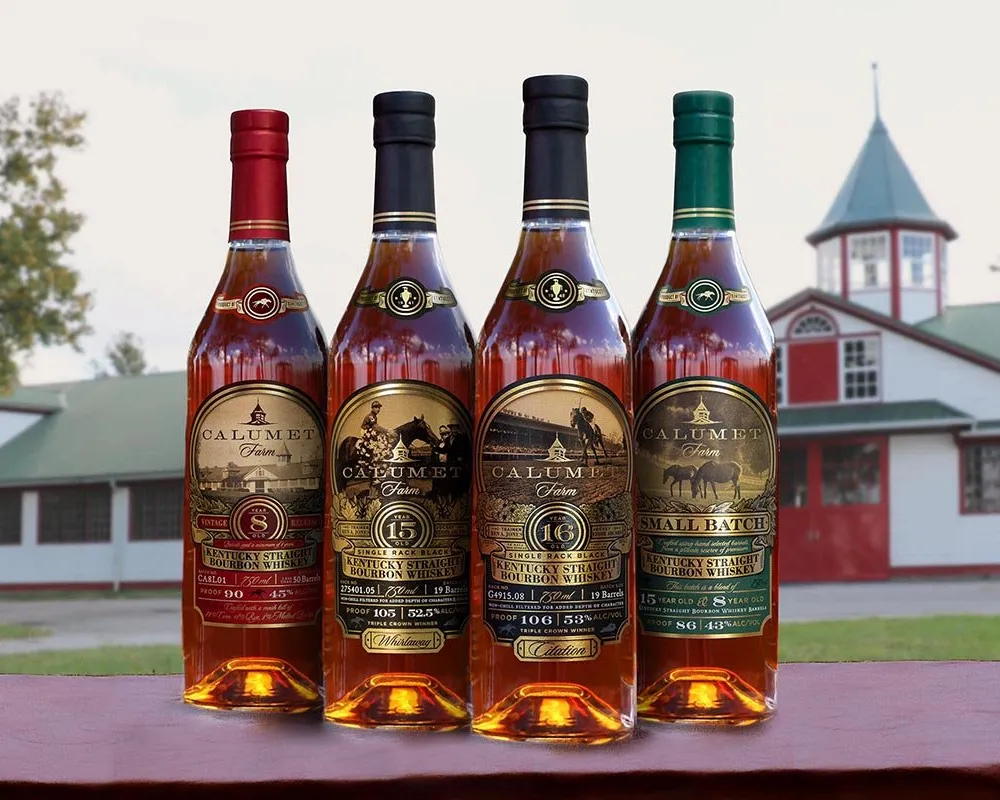 Four bottles of Calumet Farm bourbon whiskey.