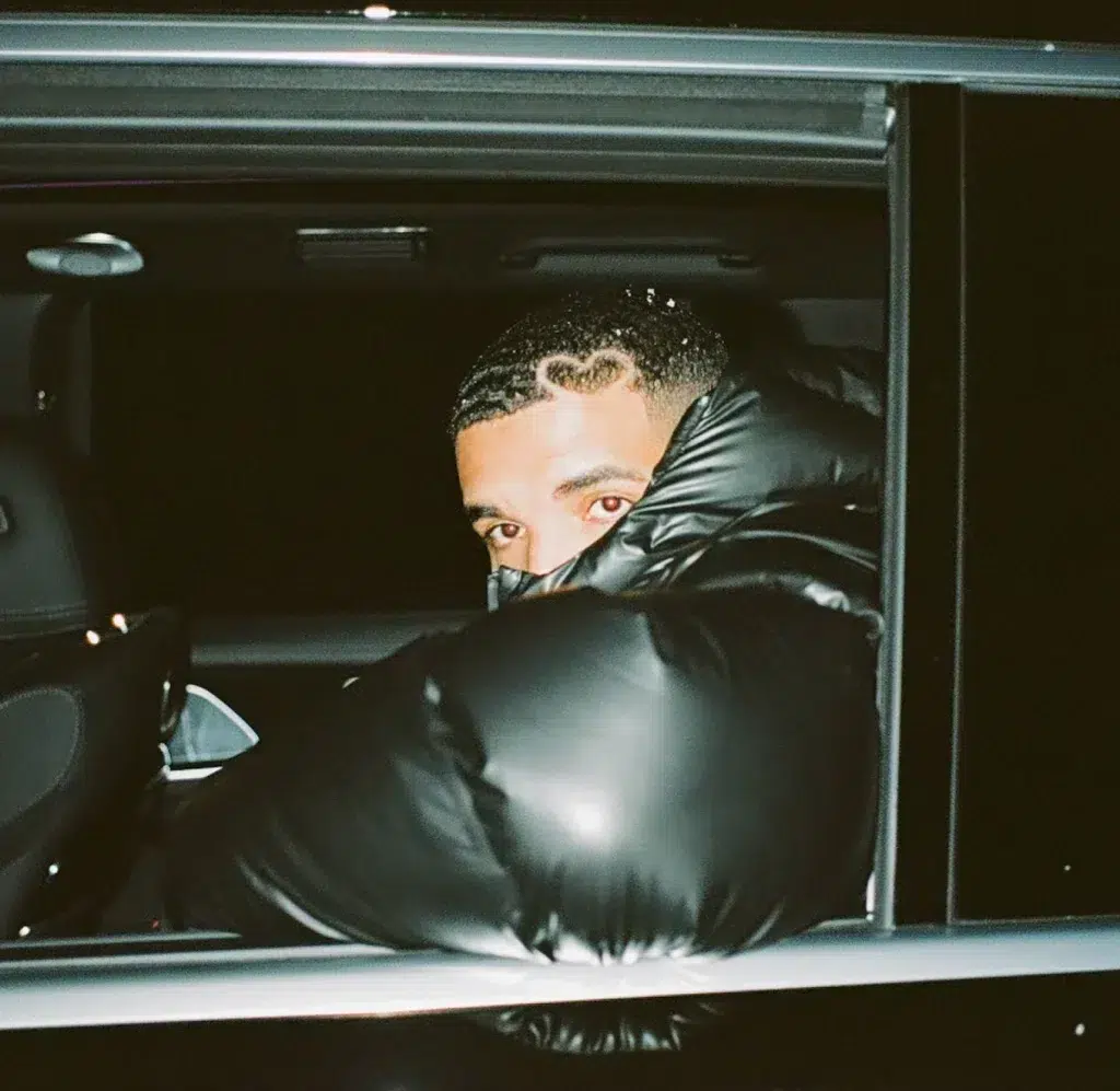 Man peeking from car window at night.