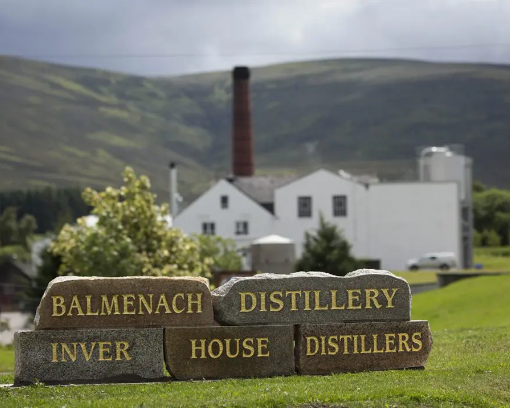 Balmenach Distillery sign, Scotland hills background