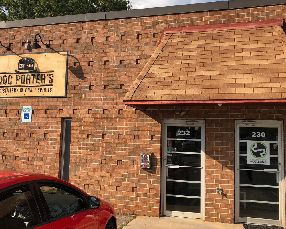 Doc Porter's distillery storefront with parking sign